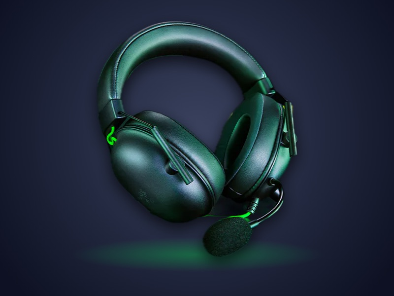 Black Razer BlackShark V2 X headset with green accents and boom mic
